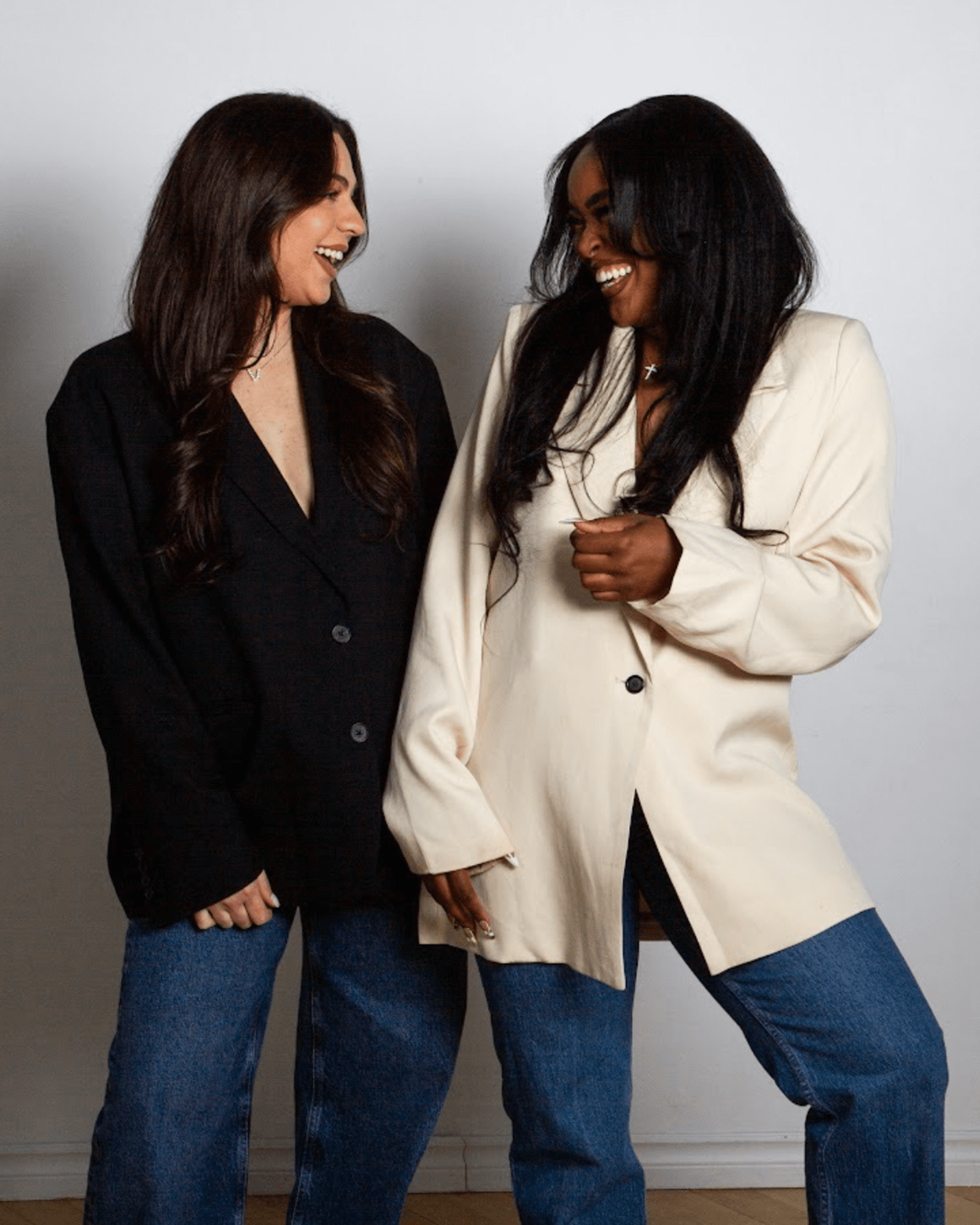 The Epic Dance Experience Two women stand side by side, smiling at each other in blazers and jeans against a plain white background—capturing the spirit of The Epic Dance Experience. Canadian Dance Competition